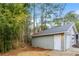 This detached garage has green siding and a white door at 4893 Autumn Cir, Stone Mountain, GA 30088