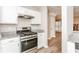 Modern kitchen featuring stainless steel appliances, granite countertops, and white cabinetry at 4893 Autumn Cir, Stone Mountain, GA 30088