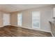 Bright living room with wood-look floors and a large window providing ample natural light at 4893 Autumn Cir, Stone Mountain, GA 30088