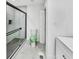 Modern bathroom with a glass shower, hexagon tile floor, and a toilet with a green lid cover at 136 Victor Nw Cir, Atlanta, GA 30314