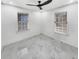 Bedroom with white walls, marble-patterned tile floors, ceiling fan, and natural light from two windows at 136 Victor Nw Cir, Atlanta, GA 30314