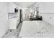 Modern kitchen features white cabinets, marble countertops, and stainless steel appliances at 136 Victor Nw Cir, Atlanta, GA 30314