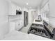 Bright kitchen with white cabinets, marble countertops, stainless steel appliances, and a view of the entry at 136 Victor Nw Cir, Atlanta, GA 30314
