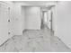 Bright living room featuring white walls, sleek marble-patterned tile flooring, and multiple entry points at 136 Victor Nw Cir, Atlanta, GA 30314