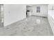 Bright living room with white walls and sleek marble-patterned tile flooring at 136 Victor Nw Cir, Atlanta, GA 30314