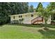 Exterior view of home featuring a well-maintained lawn and a charming back porch at 1943 Main Nw St, Atlanta, GA 30318