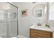 Bathroom features a glass enclosed shower, a modern vanity, and a round mirror at 1943 Main Nw St, Atlanta, GA 30318