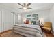 Inviting bedroom with a decorative ceiling fan, wood floors, and natural light from two windows at 1943 Main Nw St, Atlanta, GA 30318