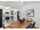Charming dining area, with a view to the kitchen, and a minimalist modern table and decor at 1943 Main Nw St, Atlanta, GA 30318