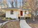 Charming home featuring a cozy front porch, manicured landscaping, and appealing architectural details at 1943 Main Nw St, Atlanta, GA 30318