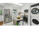 Bright kitchen features white cabinetry, stainless steel appliances, and a marble countertop island at 1943 Main Nw St, Atlanta, GA 30318