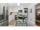 Bright kitchen features stainless steel appliances, white cabinets and backsplash and a marble island at 1943 Main Nw St, Atlanta, GA 30318