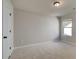 Neutral bedroom featuring a large window with natural light and plush carpet at 2208 Croghan Dr, Hampton, GA 30228