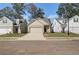 Charming new construction homes with sidewalks, manicured lawns, and inviting curb appeal on a bright, sunny day at 2208 Croghan Dr, Hampton, GA 30228