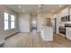 Modern eat-in kitchen featuring a stainless steel refrigerator, white cabinets, an island, and recessed lighting at 2208 Croghan Dr, Hampton, GA 30228