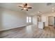 A living room area with wood flooring, a ceiling fan, and views of the neighborhood at 2208 Croghan Dr, Hampton, GA 30228