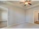 Main bedroom with trey ceiling, carpet, ceiling fan, and doorway to ensuite bath and walk in closet at 2208 Croghan Dr, Hampton, GA 30228