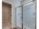 Bathroom shower enclosure featuring a glass door, built-in shelving, and a shower head at 2208 Croghan Dr, Hampton, GA 30228