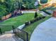 Beautiful backyard with a playset, lush grass and retaining wall at 3499 Lake Mill Rd, Buford, GA 30519