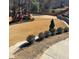 Spacious backyard featuring a playset and volleyball court, terraced with landscaping at 3499 Lake Mill Rd, Buford, GA 30519