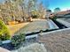 Expansive backyard featuring a playset, surrounded by a privacy fence and mature trees at 3499 Lake Mill Rd, Buford, GA 30519