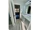 Well lit bathroom featuring dual sinks, gray cabinets, tile floors, and a stylish door at 3499 Lake Mill Rd, Buford, GA 30519