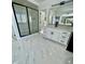 Modern bathroom with double vanity, marble floors, and glass-enclosed shower at 3499 Lake Mill Rd, Buford, GA 30519