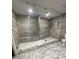 Luxurious bathroom with a large glass shower, gray tile walls, and marble floors at 3499 Lake Mill Rd, Buford, GA 30519