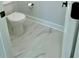 Clean half-bath with marble floors and modern fixtures at 3499 Lake Mill Rd, Buford, GA 30519
