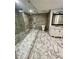 Modern bathroom with a luxurious glass shower, sleek vanity, and marble floors at 3499 Lake Mill Rd, Buford, GA 30519