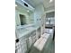 Bright bathroom features a double sink vanity with modern fixtures and gray tiled floors at 3499 Lake Mill Rd, Buford, GA 30519