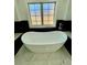 Close-up of soaking tub underneath a window at 3499 Lake Mill Rd, Buford, GA 30519