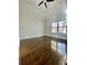 Spacious bedroom with ceiling fan and large windows showing wooded view at 3499 Lake Mill Rd, Buford, GA 30519