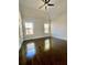 Large bedroom with ceiling fan, natural lighting and refinished hardwood floors at 3499 Lake Mill Rd, Buford, GA 30519