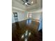 Spacious bedroom featuring a tray ceiling, ceiling fan, and gleaming hardwood floors at 3499 Lake Mill Rd, Buford, GA 30519