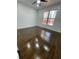 Cozy bedroom with hardwood floors and a bright window overlooking a natural landscape at 3499 Lake Mill Rd, Buford, GA 30519