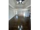 Spacious bedroom featuring a tray ceiling, ceiling fan, and gleaming hardwood floors at 3499 Lake Mill Rd, Buford, GA 30519