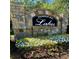 Stone Thompson Mill Lakes community sign surrounded by colorful flowerbeds at 3499 Lake Mill Rd, Buford, GA 30519