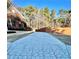 Long driveway leads to a brick home with lush greenery, offering a welcoming entrance and curb appeal at 3499 Lake Mill Rd, Buford, GA 30519