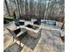 Outdoor stone firepit with seating and lush greenery at 3499 Lake Mill Rd, Buford, GA 30519