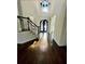 Open foyer with hardwood floors and stairway with iron railing and a view of the front door at 3499 Lake Mill Rd, Buford, GA 30519