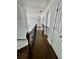 Beautiful second floor hallway with hardwood floors and wrought iron railing at 3499 Lake Mill Rd, Buford, GA 30519