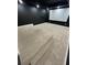 Home theater room with tiered seating and projector screen at 3499 Lake Mill Rd, Buford, GA 30519