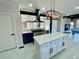 Beautiful kitchen with island, gas range, and a combination of white and blue cabinets at 3499 Lake Mill Rd, Buford, GA 30519