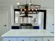Close-up of kitchen island with stainless appliances, cooktop, blue accents and modern lighting at 3499 Lake Mill Rd, Buford, GA 30519