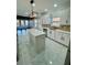 Open kitchen with island, sleek white cabinets, and stainless steel appliances at 3499 Lake Mill Rd, Buford, GA 30519