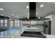 Bright kitchen features stainless steel appliances, white cabinets, and a large island with seating at 3499 Lake Mill Rd, Buford, GA 30519