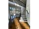 Bright living room with hardwood floors, large windows, and staircase to second floor at 3499 Lake Mill Rd, Buford, GA 30519