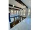 Bright living room with large windows and exposed beams, showcasing natural light at 3499 Lake Mill Rd, Buford, GA 30519