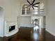 Spacious living room with fireplace, balcony, and dark hardwood floors at 3499 Lake Mill Rd, Buford, GA 30519